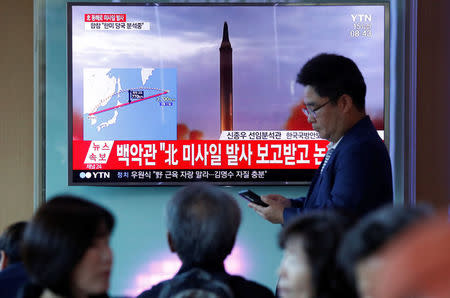 People watch a television broadcasting a news report on North Korea firing a missile that flew over Japan's northern Hokkaido far out into the Pacific Ocean, in Seoul, South Korea, September 15, 2017. REUTERS/Kim Hong-Ji