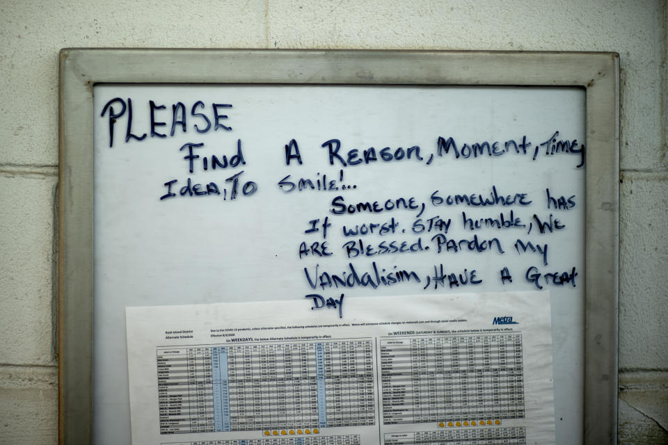 A motivational message is written on a timetable at a Metra train line station in the Auburn Gresham neighborhood in Chicago, Thursday, Aug. 27, 2020. As this agonizing year nears an end, some in Auburn Gresham are looking ahead, with hope. (AP Photo/David Goldman)