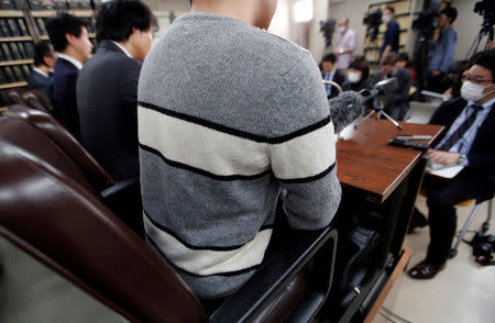 A man in his 20s who had invested 400,000 yen in digital money at Coincheck, attends a news conference after a group of seven investors filed a suit at the Tokyo District Court, in Tokyo, Japan, February 15, 2018. REUTERS/Toru Hanai