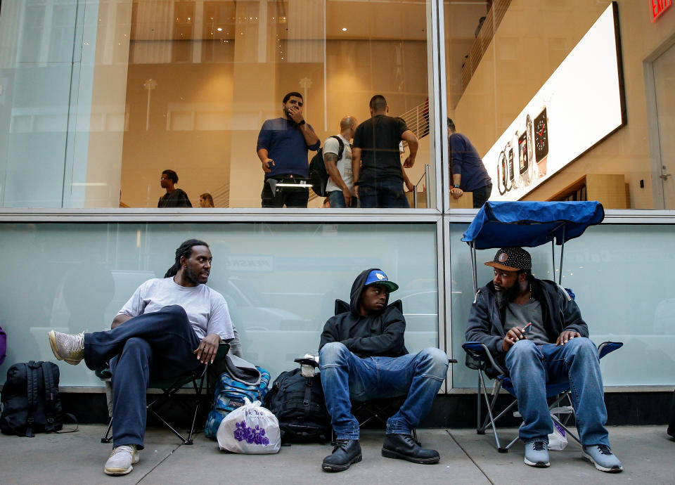 Customers wait in line for the new iPhone X outside an Apple store in New York City