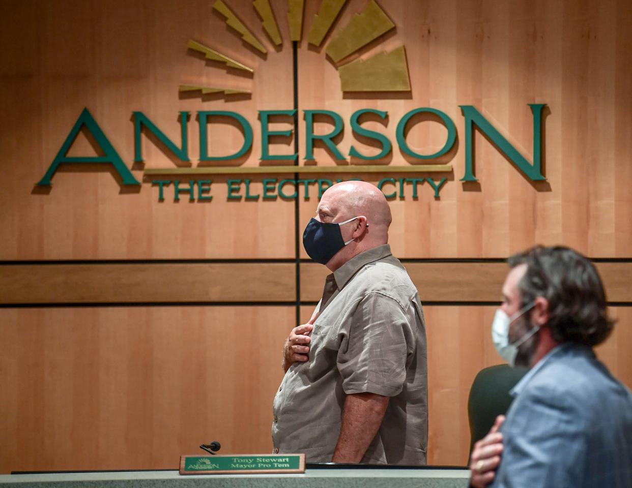 Anderson City Council members Tony Stewart, left, and John Roberts join in the Pledge of Allegiance before unanimously approving the emergency ordinance requiring masks in retail establishments, barber shops and salons, at their meeting in the council chambers in Anderson Thursday, July 23, 2020. 