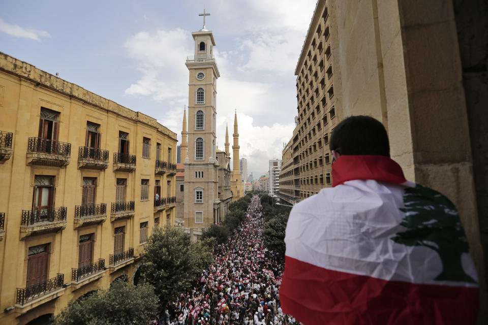 Anti-government protesters shout slogans in Beirut, Lebanon, Sunday, Oct. 20, 2019. Thousands of people are gathering in downtown Beirut as Lebanon is expected to witness the largest protests on the fourth day of anti-government demonstrations. (AP Photo/Hassan Ammar)