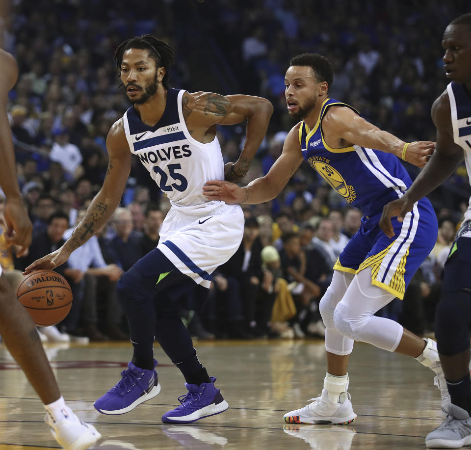 Minnesota Timberwolves' Derrick Rose, left, drives the ball past Golden State Warriors' Stephen Curry (30) during the first half of an NBA basketball game Friday, Nov. 2, 2018, in Oakland, Calif. (AP Photo/Ben Margot)