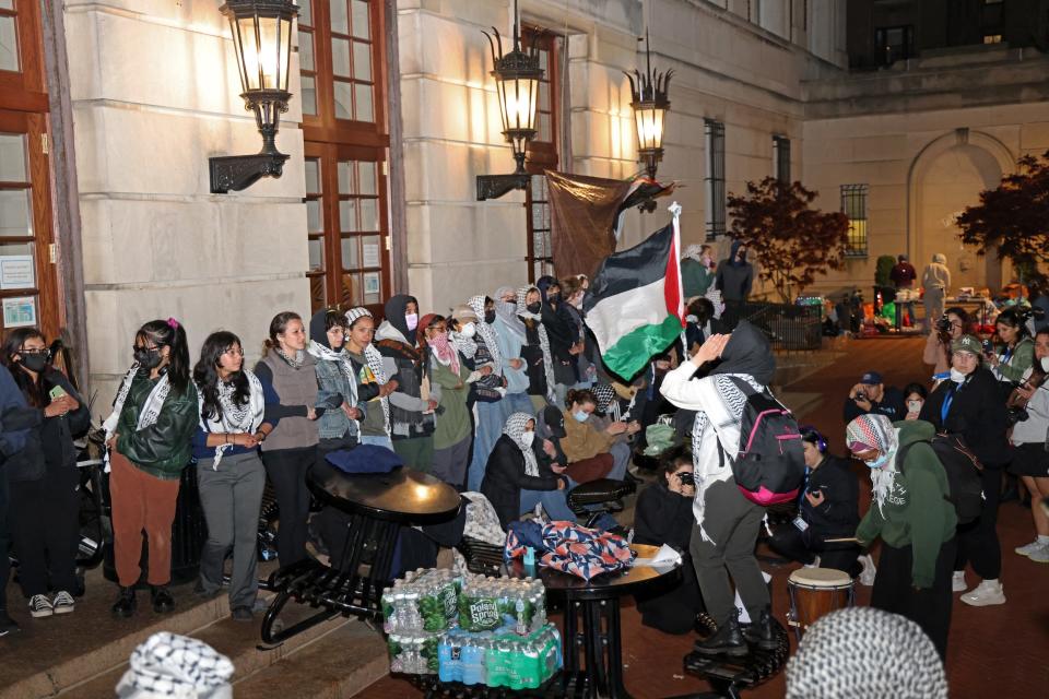 Pro-Palestinian student protesters lock arms at the entrance to Hamilton Hall