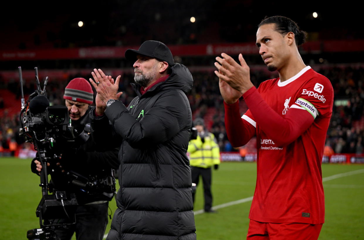 Liverpool captain Virgil van Dijk (right) and manager Jurgen Klopp applauding their fans at the end of their English Premier League match against Manchester United at Anfield.