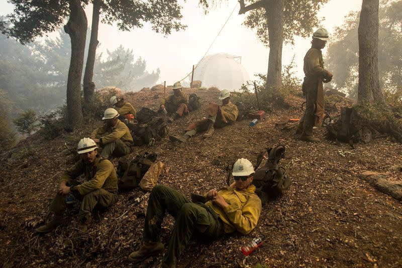 Firefighters rest while defending the Mount Wilson observatory during the Bobcat Fire in Los Angeles