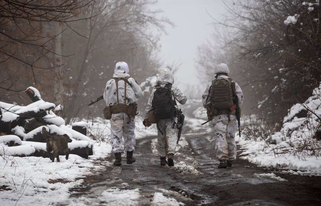 File photo: Ukrainian soldiers walk at the line of separation from pro-Russian rebels near Katerinivka in Donetsk region, Ukraine, 7 December 2021  (Copyright 2021 The Associated Press. All rights reserved.)