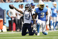 Tennessee Titans wide receiver DeAndre Hopkins (10) signals for a first down after catching a pass next to Los Angeles Chargers safety Derwin James Jr. (3) during the second half of an NFL football game Sunday, Sept. 17, 2023, in Nashville, Tenn. (AP Photo/George Walker IV)