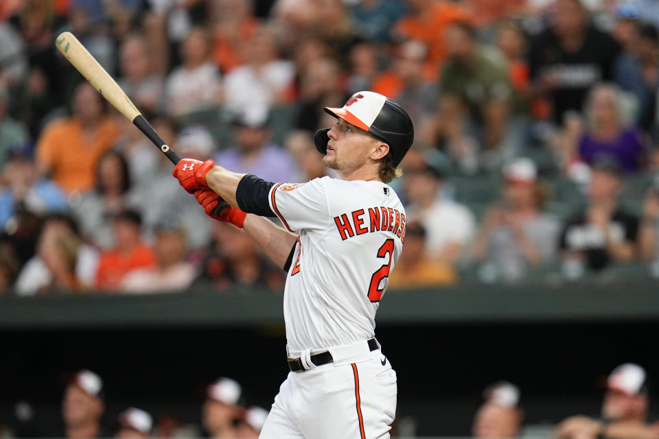 Baltimore Orioles' Gunnar Henderson watches his ball as he hits a grand slam home run off Toronto Blue Jays starting pitcher Chris Bassitt during the third inning of a baseball game, Tuesday, June 13, 2023, in Baltimore. Orioles' Aaron Hicks, Ramon Urias and Jorge Mateo scored on the home run. (AP Photo/Julio Cortez)