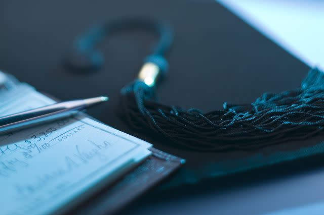 Getty Images/Comstock Images Stock image of a checkbook next to a graduation cap