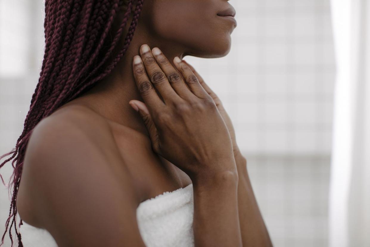 a woman touching her neck