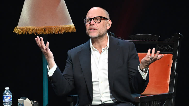 Alton Brown sitting on stage