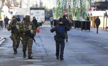 Belgian soldiers and police patrol in central Brussels as police searched the area during a continued high level of security following the recent deadly Paris attacks, Belgium, November 23, 2015. REUTERS/Yves Herman