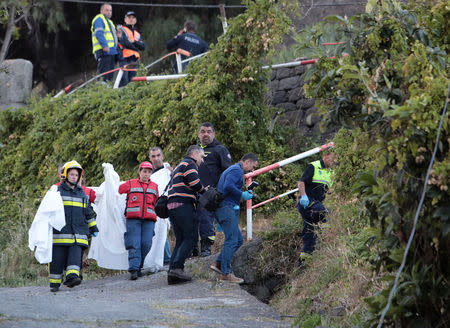 Forensic and rescue workers stand at the scene of a bus accident in Canico, in the Portuguese Island of Madeira, April 17, 2019. REUTERS/Duarte Sa