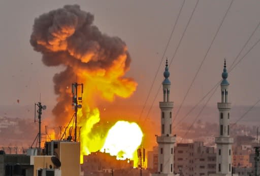 A fireball erupts over Gaza City as Israeli aircraft and tanks hit targets across the territory on July 20, 2018, after a soldier was shot dead on the border