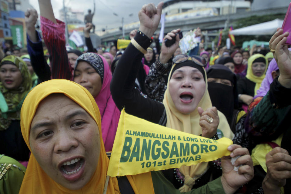 Filipino Muslims cheer after learning that a peace accord has been signed between Moro Islamic Liberation Front leaders and Philippine President Benigno Aquino III during a rally Thursday March 27, 2014 outside the presidential palace in Manila, Philippines. The Philippine government signed a peace accord with the country's largest Muslim rebel group on Thursday, the culmination of years of negotiations and a significant political achievement for President Benigno Aquino III. (AP Photo)