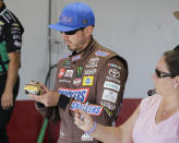 Kyle Busch signs an autograph before practice for a NASCAR auto race on Friday, Aug. 30, 2019, in Darlington, S.C.. (AP Photo/Terry Renna)