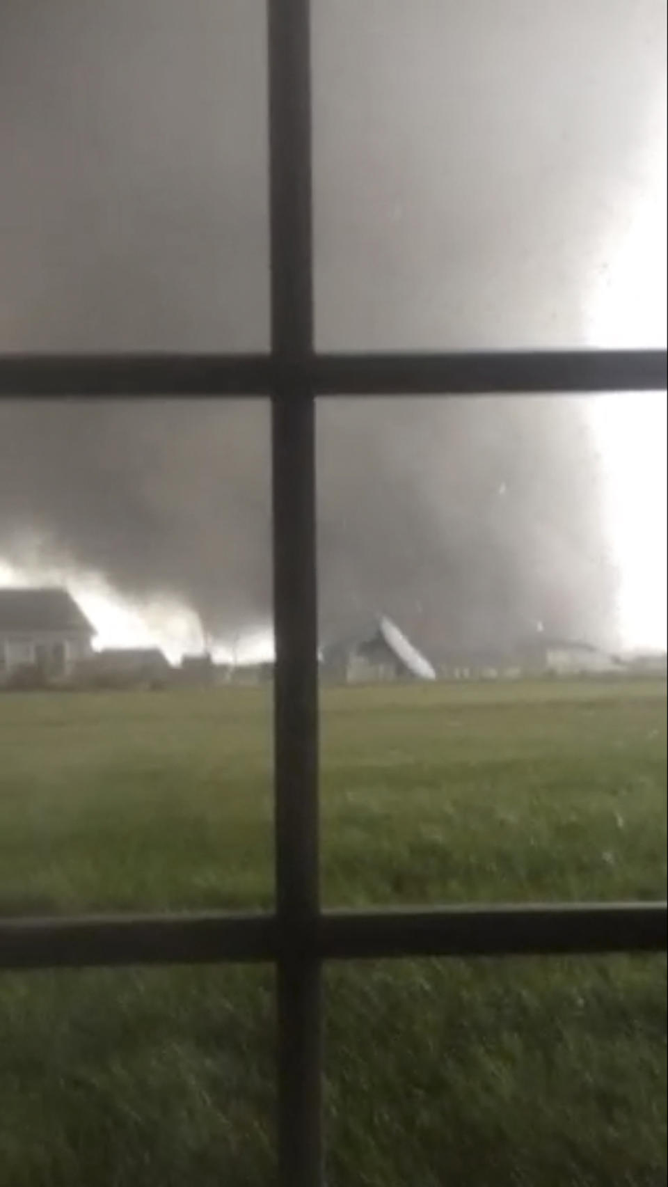 An active tornado is seen through a window as it touches down in Washington, Illinois on November 17, 2013, in this still image captured from a video courtesy of Anthony Khoury. A fast-moving storm system spawned multiple tornadoes in Illinois and Indiana, threatening some 53 million people across 10 Midwestern states on Sunday, U.S. weather officials said. Washington, Illinois is located 145 miles (233 km) southwest of Chicago. REUTERS/Anthony Khoury/Handout via Reuters (UNITED STATES - Tags: DISASTER ENVIRONMENT) ATTENTION EDITORS - THIS IMAGE HAS BEEN SUPPLIED BY A THIRD PARTY. IT IS DISTRIBUTED, EXACTLY AS RECEIVED BY REUTERS, AS A SERVICE TO CLIENTS. NO SALES. NO ARCHIVES. FOR EDITORIAL USE ONLY. NOT FOR SALE FOR MARKETING OR ADVERTISING CAMPAIGNS. MANDATORY CREDIT