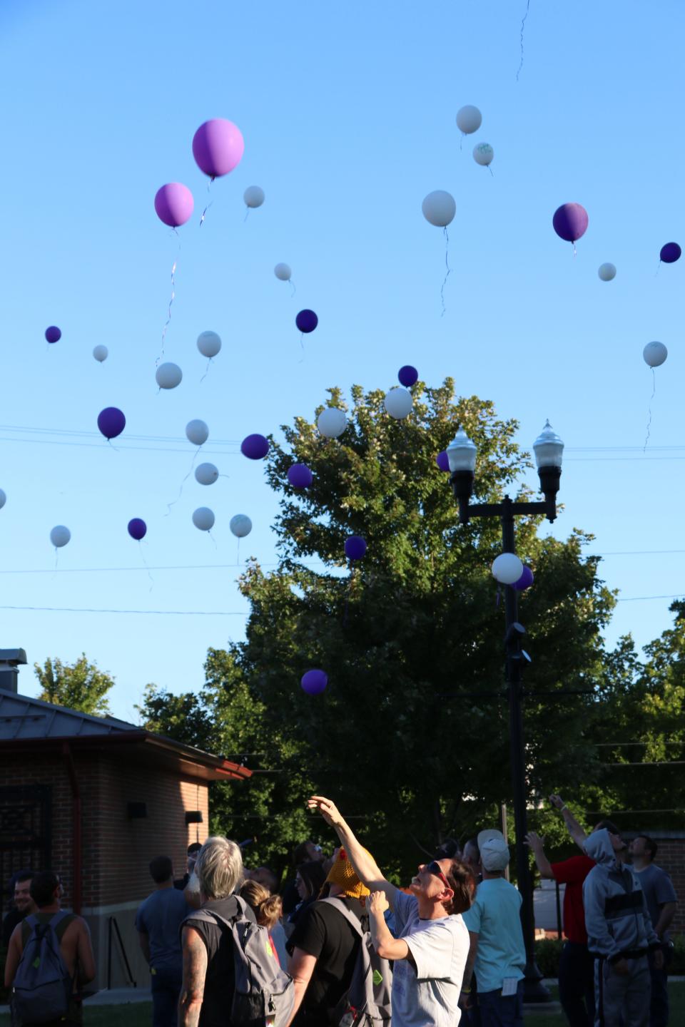 Nestor Matthews, a volunteer with Newark Homeless Outreach, joins others at an Aug. 31, event in releasing balloons in memory of those who died.