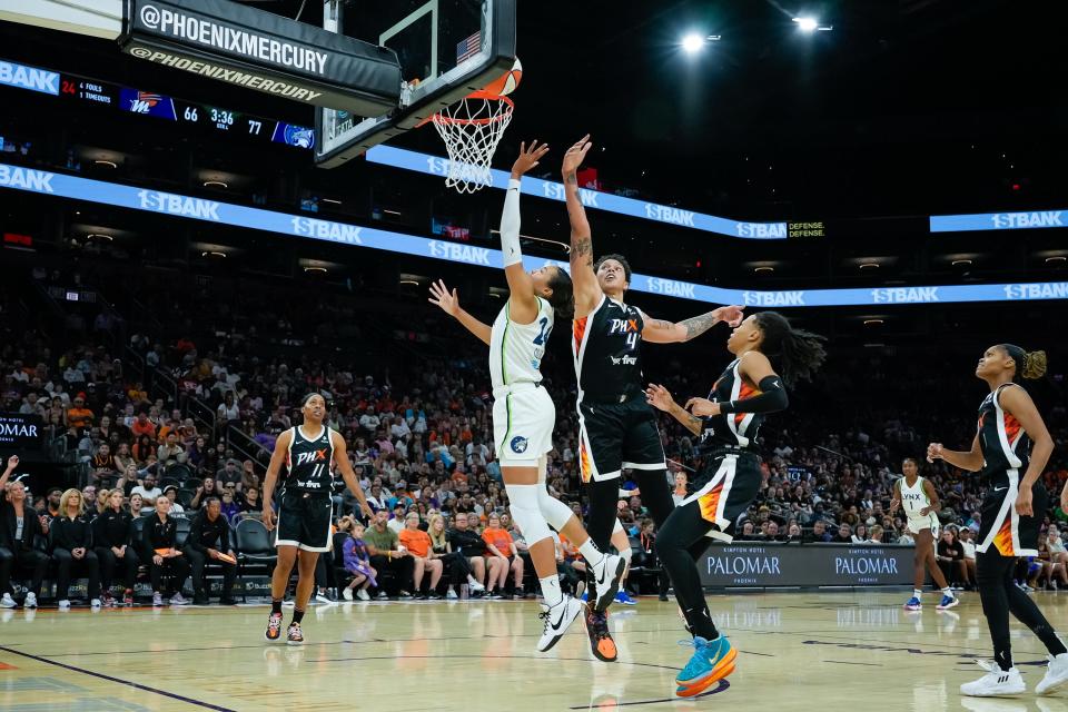 Napheesa Collier (24) of the Minnesota Lynx goes for a layup as Brittney Griner (42) of the Phoenix Mercury attempt to block her during a game at the Footprint Center on July 1, 2023, in Phoenix.