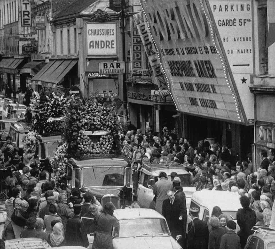 FILE - The funeral procession for entertainer Josephine Baker passes in front of the Bobino Theatre, April 15, 1975, where the American-born singer gave her last show shortly before she died at age 69. France is inducting Josephine Baker – Missouri-born cabaret dancer, French Resistance fighter and civil rights leader – into its Pantheon, the first Black woman honored in the final resting place of France's most revered luminaries. (AP Photo, File)