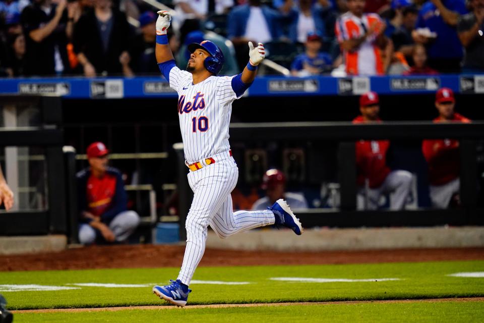 New York Mets' Eduardo Escobar celebrates as he runs the bases after hitting a home run during the fourth inning in the second baseball game of a doubleheader against the St. Louis Cardinals Tuesday, May 17, 2022, in New York.