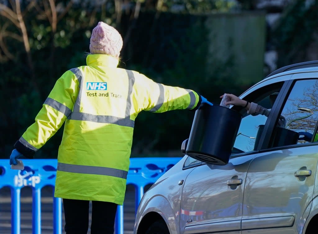 A member of NHS Test and Trace collects a sample from a member of the public at a Covid-19 testing site in Bournemouth (Andrew Matthews/PA) (PA Wire)