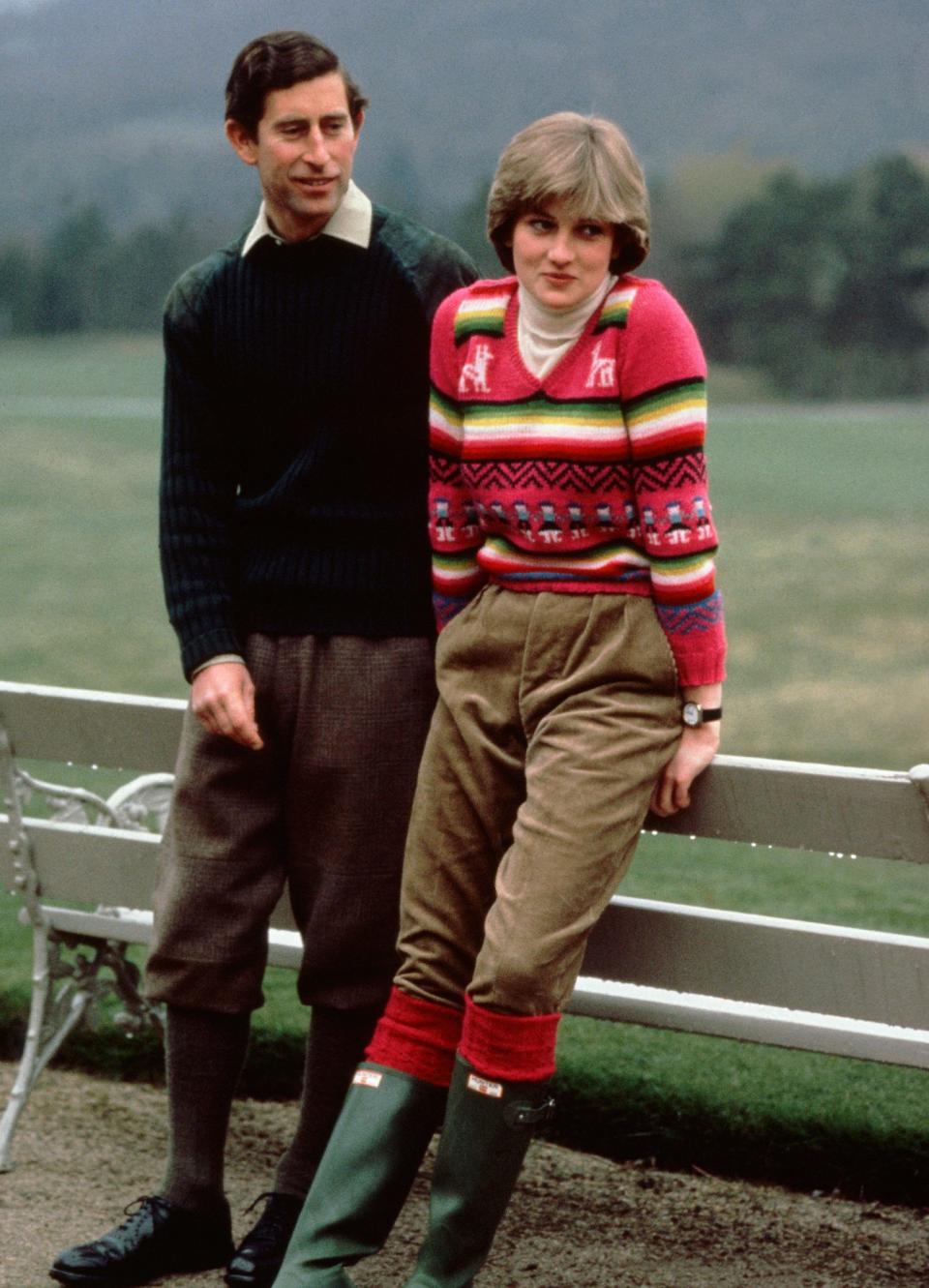 <p>Ahead of their royal wedding, Princess Diana posed for a photo with Prince Charles at Balmoral wearing a pink patterned pullover with trousers and boots.</p>