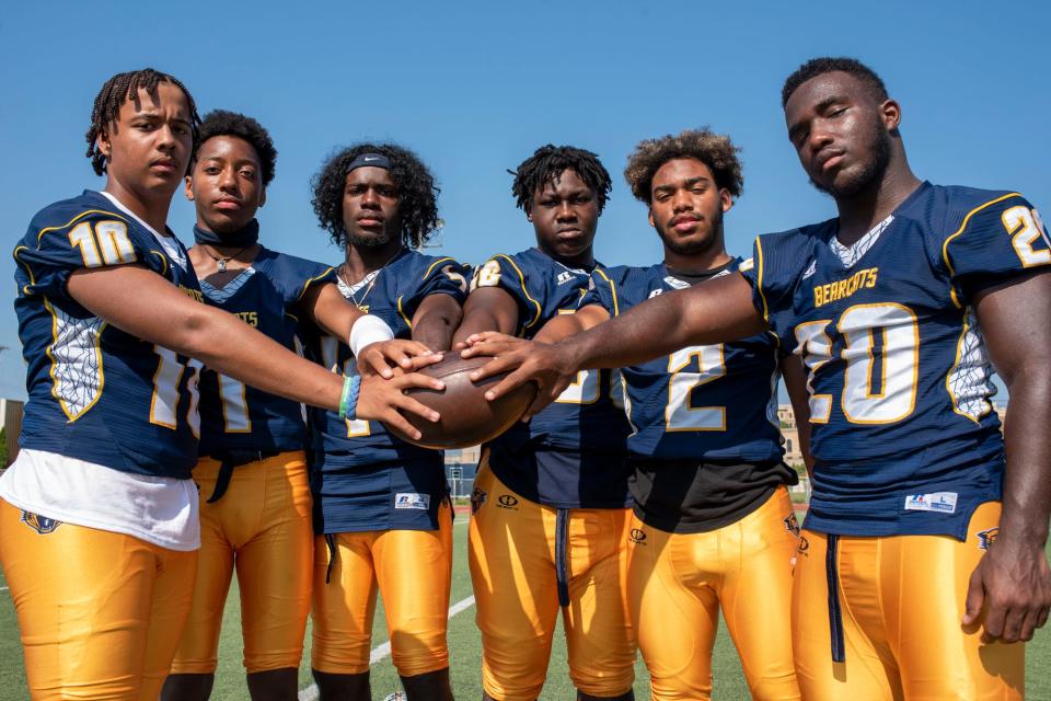 Battle Creek Central's Devoine Newton (10), Jesse Coffey (1), Kylon Wilson (4), Chris Williams (56), Asael Adon (2) and Kaijehl Williams (20) pose for a photograph on Friday, Aug. 20, 2021 at Battle Creek Central High School.