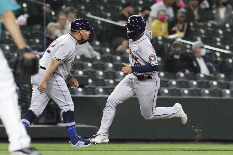 Houston Astros' Alexander De Goti rounds third on the way to scoring on a double by Chas McCormick during the fifth inning of the team's baseball game against the Seattle Mariners on Friday, April 16, 2021, in Seattle. (AP Photo/Jason Redmond)