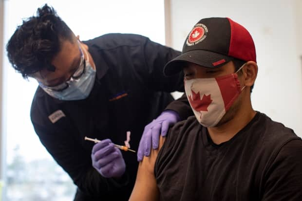 Team Canada wheelchair rugby player Travis Murao, 38, gets his second dose of the Pfizer-BioNTech COVID-19 vaccine at a clinic for Olympic athletes at the Pan Am Centre in Toronto on May 28, 2021. (Evan Mitsui/CBC - image credit)