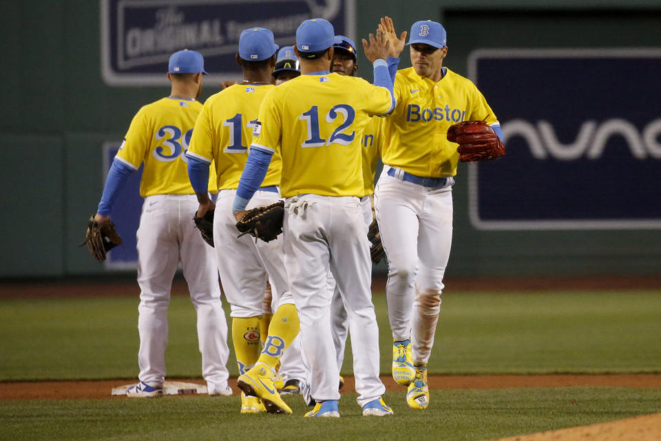 Boston Red Sox players celebrate their win over the Chicago White Sox at the end of the baseball game, Saturday, April 17, 2021, in Boston. (AP Photo/Mary Schwalm)