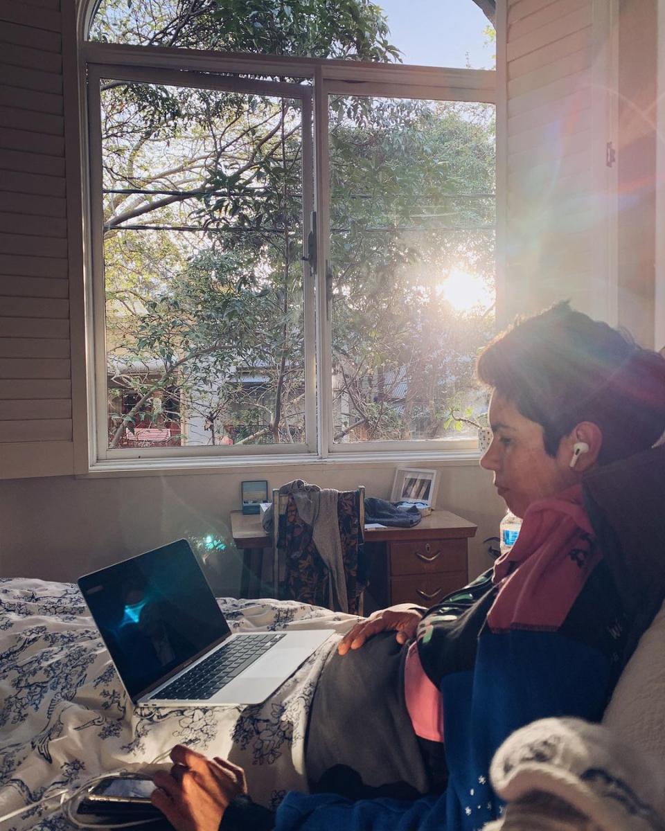 Narelda Jacobs sitting in bed with an open laptop on her lap. Photo: Instagram/narelda_jacobs