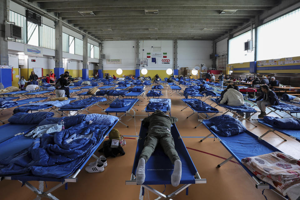 Evacuees rest in a gymnasium in Bologna, Italy, Thursday, May 18, 2023. Rescue crews worked Thursday to reach towns and villages in northern Italy that were cut off from highways, electricity and cell phone service following heavy rains and flooding, as farmers warned of “incalculable” losses and authorities began mapping out cleanup and reconstruction plans. (Guido Calamosca/LaPresse via AP)