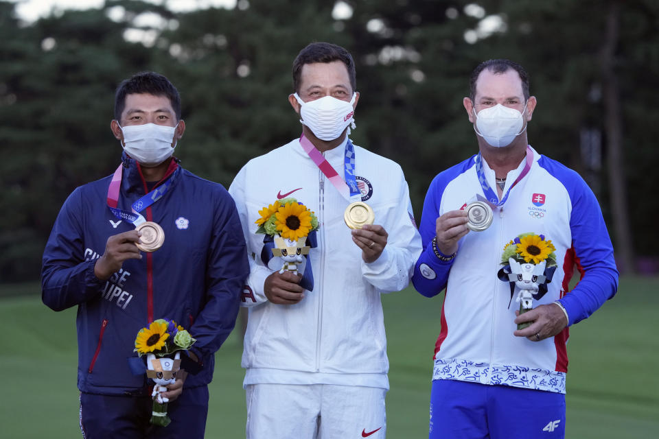 <p>Xander Schauffele, of the United States, poses with his gold medal next to bronze medal winner C.T. Pan of Taiwan, left, and silver medal winner Rory Sabbatini, of Slovakia, right, for the men’s golf at the 2020 Summer Olympics on Sunday, Aug. 1, 2021, in Kawagoe, Japan. (AP Photo/Andy Wong)</p>
