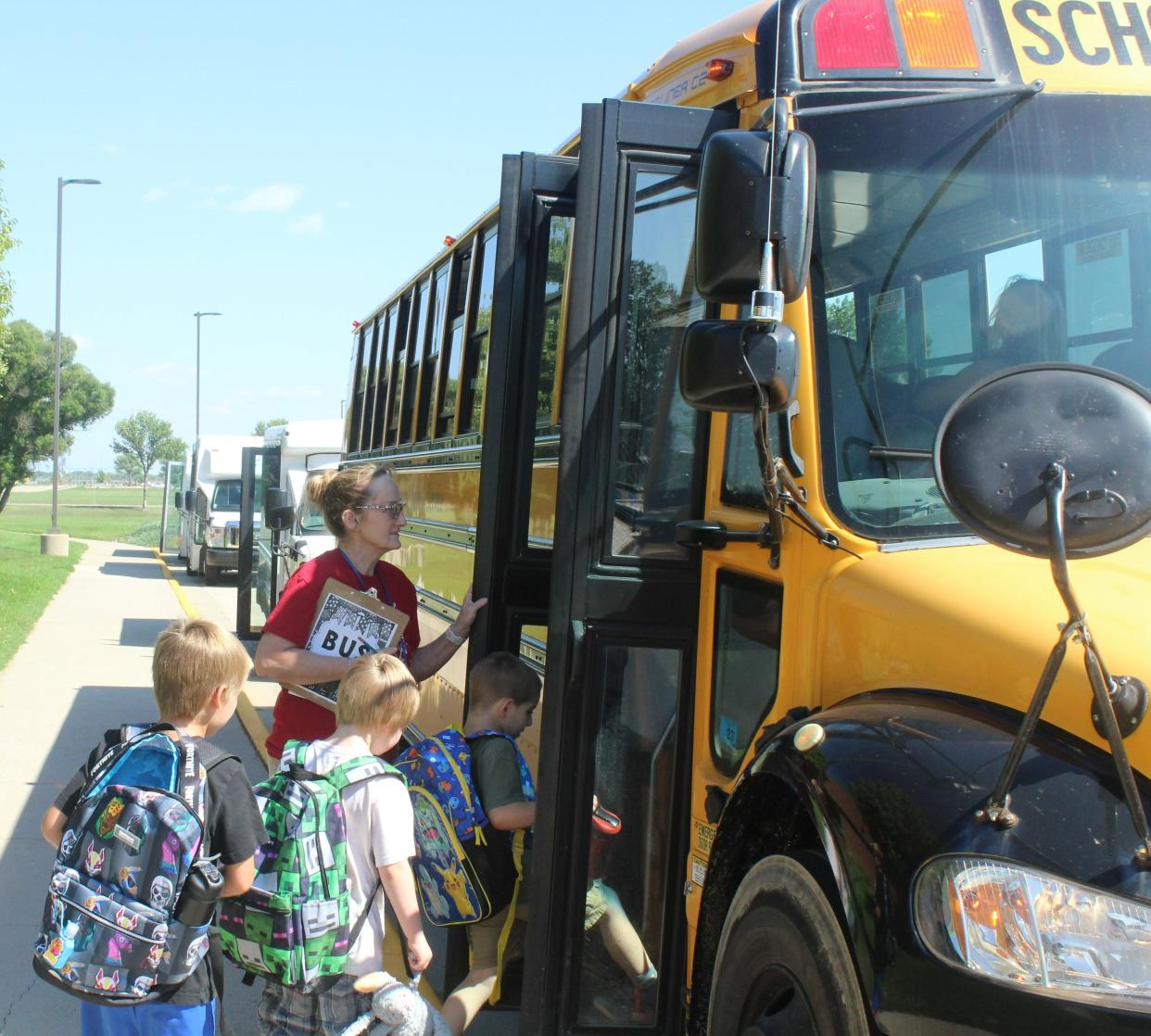 Students board a bus owned by Foreman Bus Sales & Service at Mike Miller Elementary School in Aberdeen Monday afternoon.