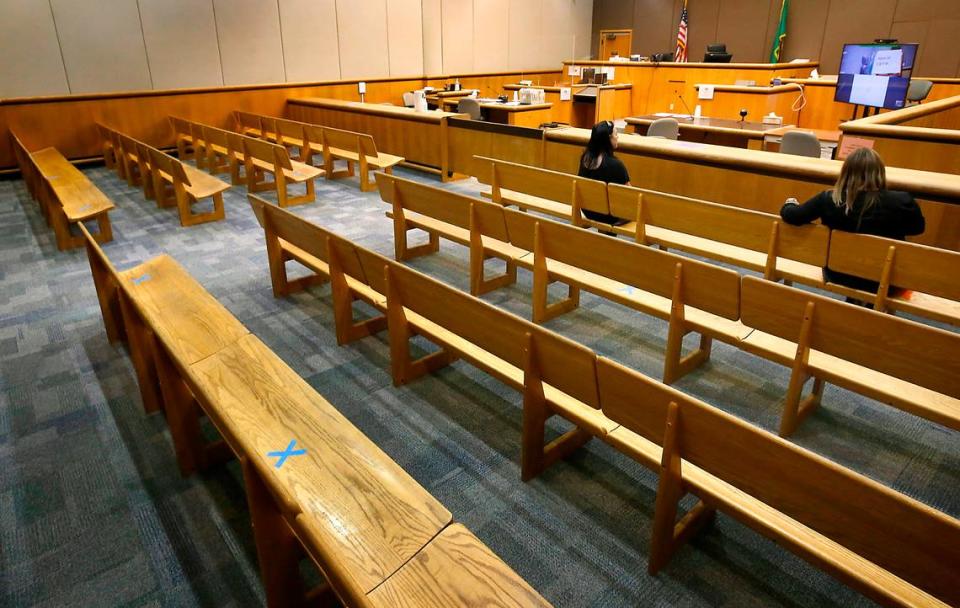 Blue tape X’s mark spots on benches in a Benton County Superior courtroom where public seating is available to maintain proper social distancing guidelines during the coronavirus pandemic.  