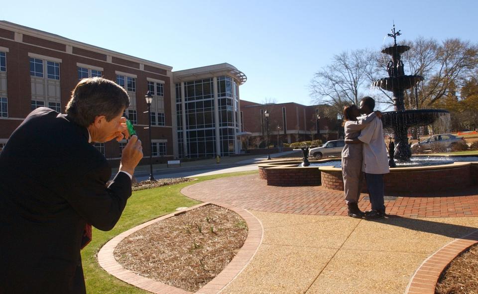 Augusta State University president Dr. William A Bloodworth, Jr. takes the photo of visitors Diamond Holmes, left, and her boyfriend Charles Fields on March 5, 2007. The fountain was one of many campus additions Bloodworth oversaw.