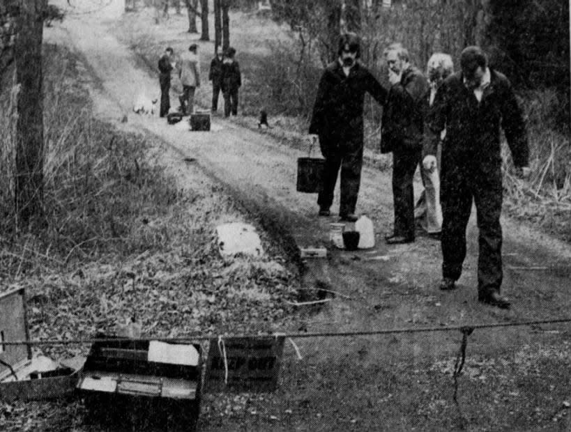 Somerset County detectives comb the estate of Stephen Lombardi in Bridgewater for clues in the murder of an unidentified man found Wednesday, March 6, 1974, during a manhunt for two bank robbers. Four hours of searching turned up no clues or weapon in the fatal stabbing.