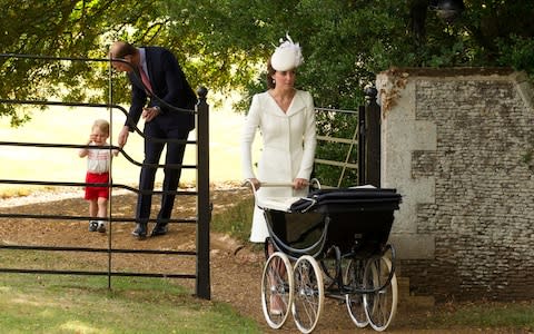 Rising above it: the old-fashioned pram used here for Princess Charlotte's christening could afford her more protection - Credit: AP