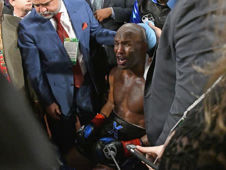 Dec 17, 2016; Los Angeles, CA, USA; Bernard Hopkins receives medical attention after he fell out of the ring in seventh round. Hopkins did not return to the ring in the required 20 seconds and Joe Smith Jr. was awarded the win on a TKO in their light heavyweight boxing fight at The Forum. Mandatory Credit: Jayne Kamin-Oncea-USA TODAY Sports