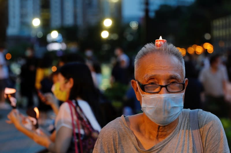 Protesters take part in a candlelight vigil to mark the 31st anniversary of the crackdown of pro-democracy protests at Beijing's Tiananmen Square in 1989, in Hong Kong