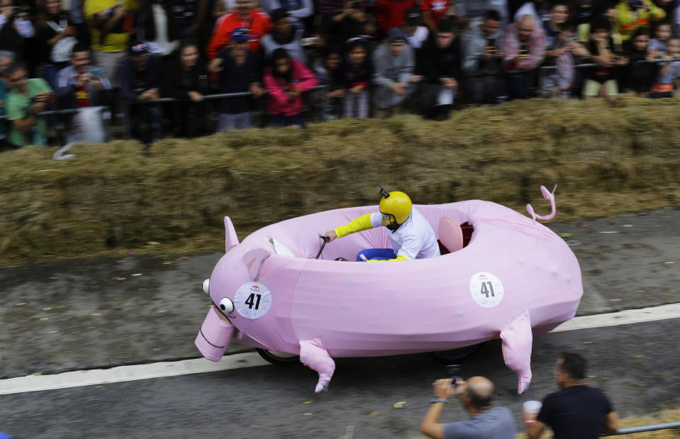 In this April 14, 2019 photo, a competitor in a vehicle that looks like a pig steers through an obstacle course during the Red Bull Soapbox Race in Sao Paulo, Brazil. (AP Photo/Nelson Antoine)