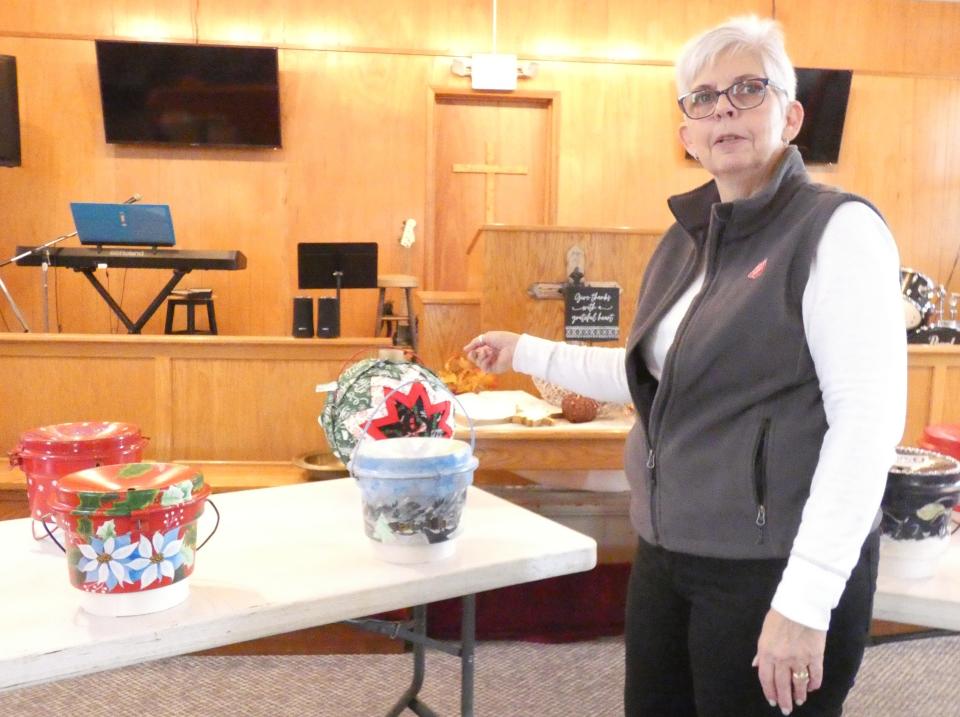 Major Debbra Grace, one of the Bucyrus Salvation Army's commanders, shows off the "Pretty Painted Pots" that will make their debut at the kettle campaign's kickoff event, 9 a.m. Friday at Bucyrus City Hall.