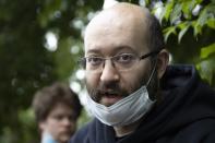 Prominent Russian journalist Ilya Azar, who was sentenced for holding a one-person protest amid lockdown, speaks to the media shortly after his release in Moscow, Russia, Sunday, June 7, 2020. A Russian journalist whose jailing prompted protests in which police detained demonstrators has been released. The detentions brought criticism that authorities were using coronavirus restrictions to suppress opposition. Ilya Azar was sentenced to 15 days in jail on May 28, but was released Sunday after a court reduced his sentence. Azar was arrested after holding a one-man picket outside police headquarters in Moscow against the jailing on extortion charges of an activist who monitors police corruption. (AP Photo/Alexander Zemlianichenko)