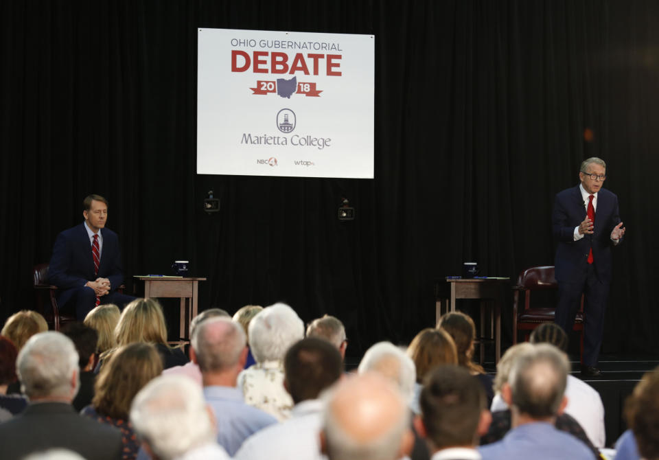 Ohio Attorney General and Republican gubernatorial candidate Mike DeWine, right, speaks as Democratic gubernatorial candidate Richard Cordray listens during a debate at Marietta College in Marietta, Ohio, Monday, Oct. 1, 2018. (AP Photo/Paul Vernon, Pool)