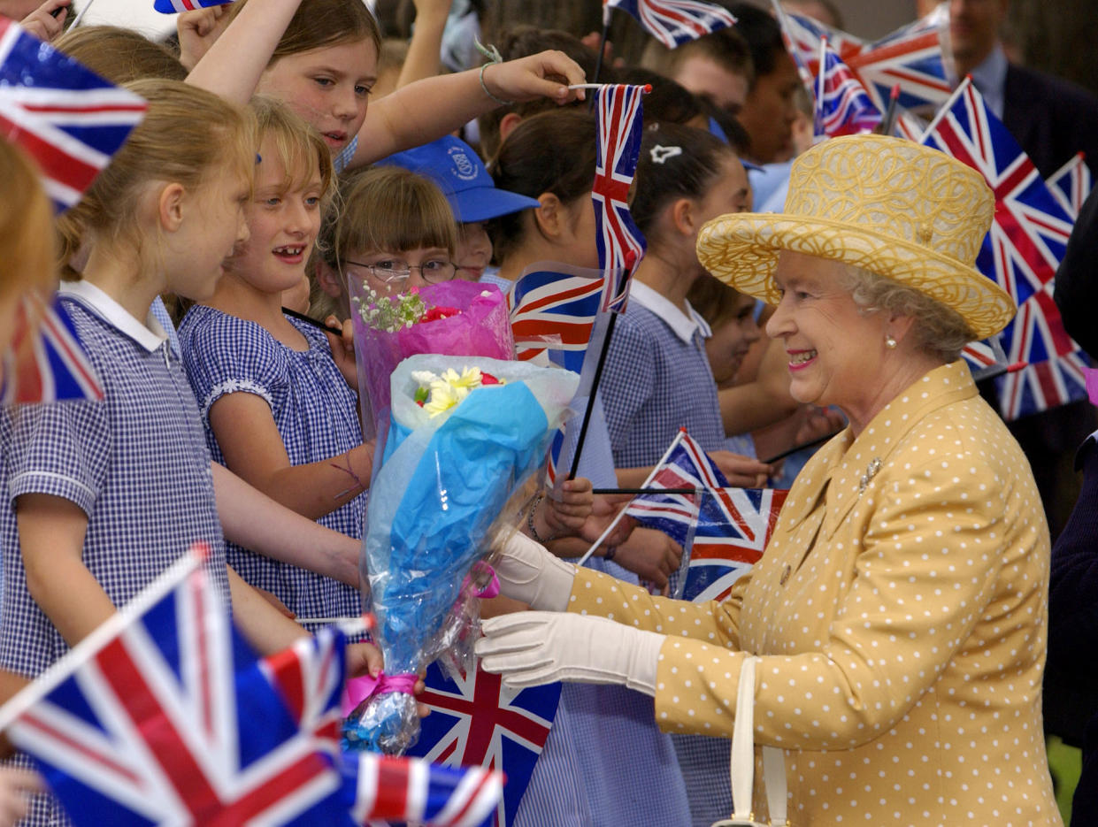 The Queen greets people during a tour of the UK during the Golden Jubilee. (Getty)