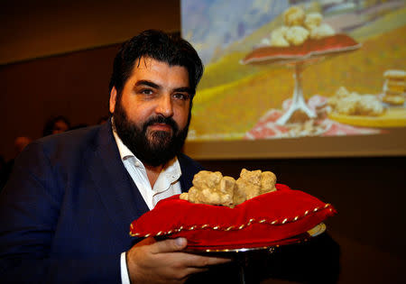 Italian chef Antonino Cannavacciuolo holds a set of truffles weighing 850 grams during the international auction for truffles at the Grinzane Castle in Grinzane Cavour near Alba, Italy, November 12, 2017. REUTERS/ Stefano Rellandini