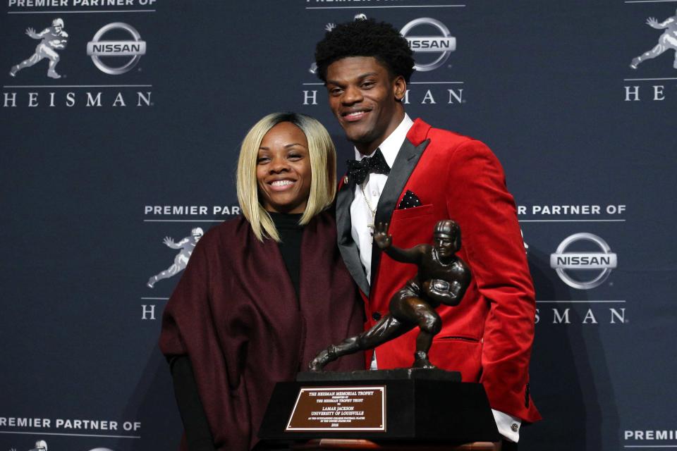 Dec 10, 2016; New York, NY, USA;  Louisville quarterback Lamar Jackson and his mother Felicia Jones pose with the trophy during a press conference at the New York Marriott Marquis after winning the 2016 Heisman Trophy award during a presentation at the Playstation Theater. Mandatory Credit: Brad Penner-USA TODAY Sports