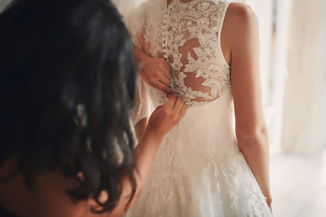 <p>Getty</p> Stock photo of a bride and maid of honor getting ready